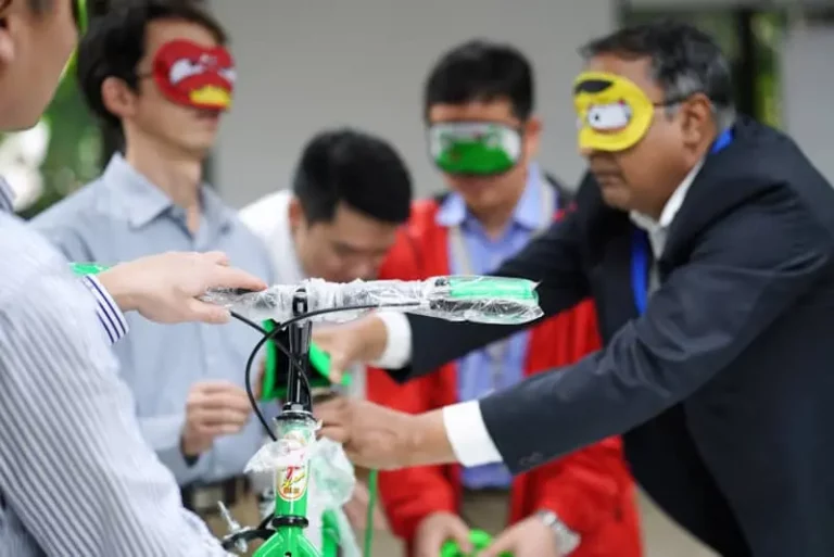 Blindfolded team assembles a bike