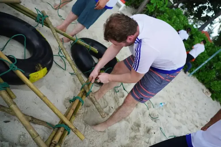 Participant ties a bamboo raft together