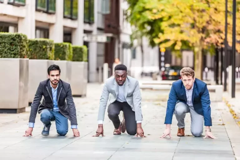Three business men getting ready to race each other